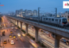 Namma Metro Crosses 100 km as Pink Line Gets Safety Clearance Generic elevated modern metro train running on a concrete viaduct over a busy Indian road during blue hour with traffic light trails.